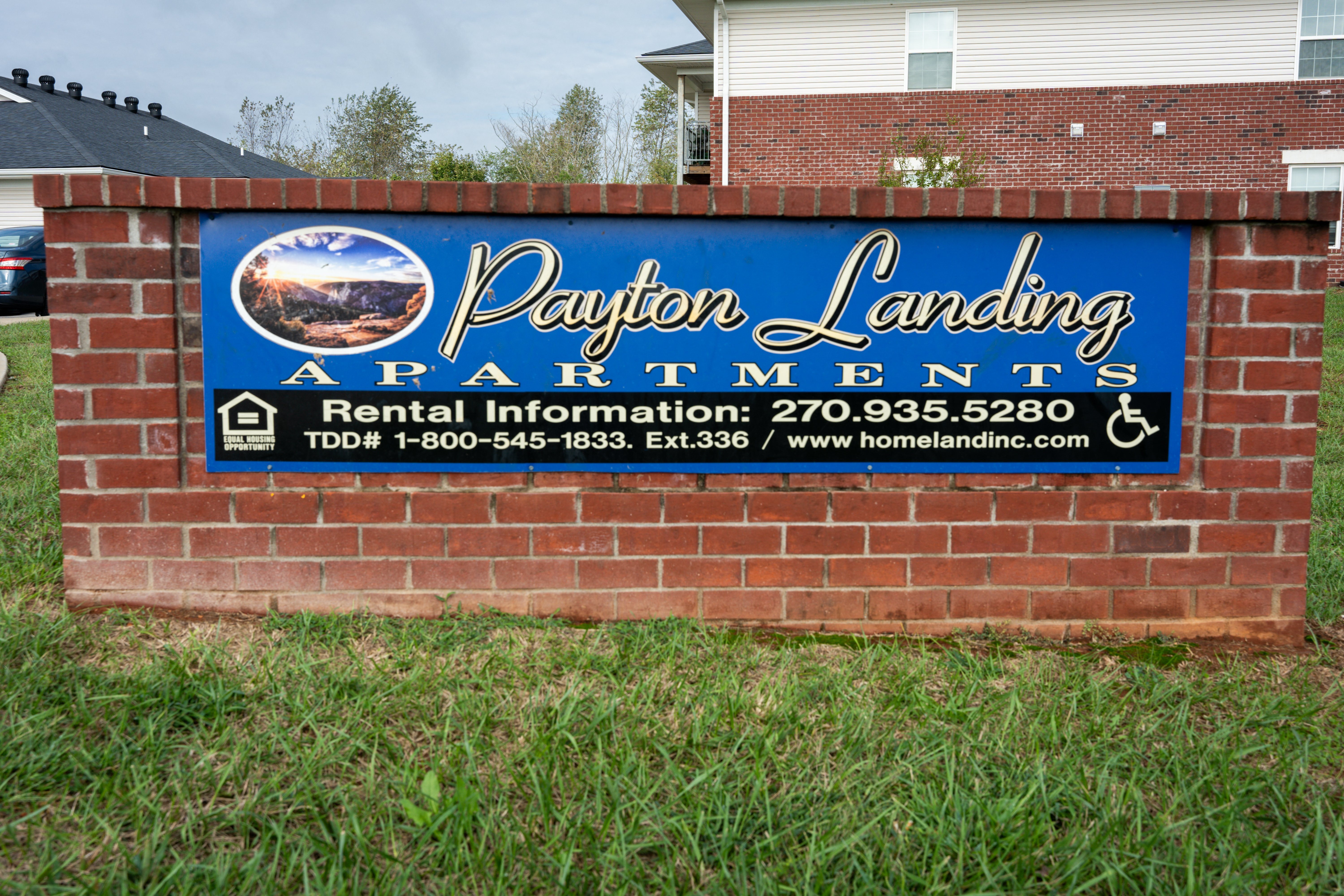 a sign for the paylor landing apartments sign on a brick wall